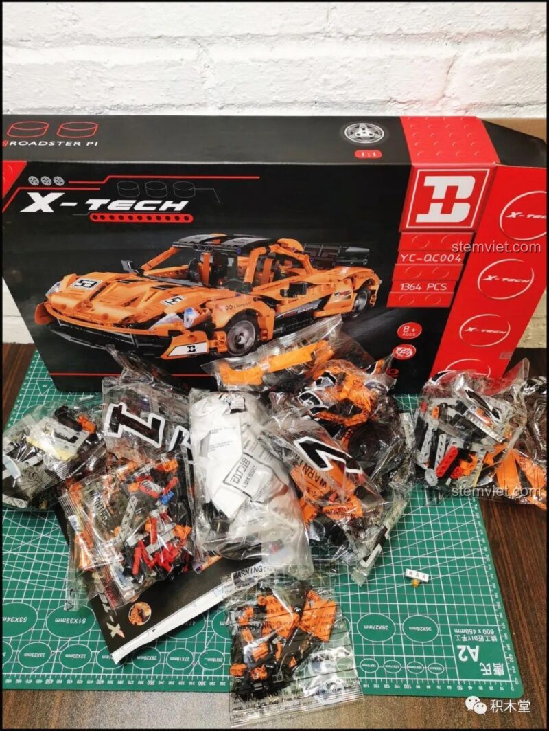 Hộp và các túi mảnh ghép của Bộ đồ chơi Siêu xe McLaren P1 Happy Build YC-QC004, sẵn sàng cho trải nghiệm lắp ráp đầy thử thách và sáng tạo cho bé trai 6 tuổi.
