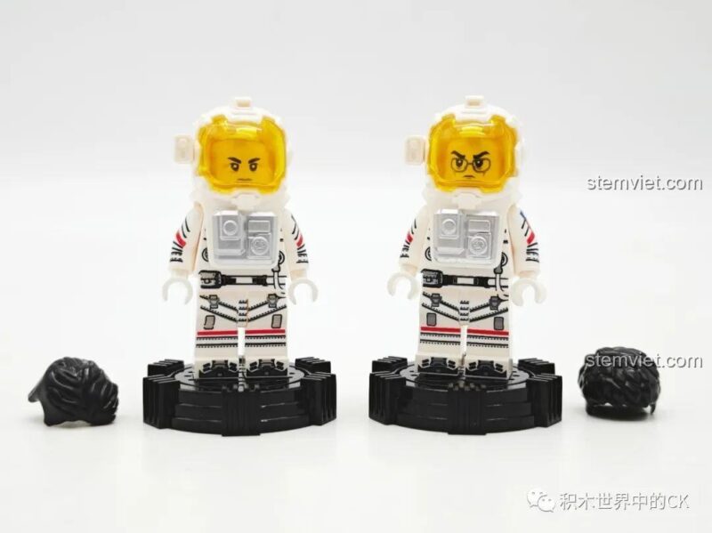 Hai minifigure phi hành gia cùng với tóc và đế trưng bày riêng.
