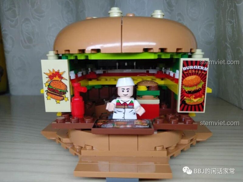 Minifigure đầu bếp đang đứng bên trong quầy hàng của bộ lắp ráp Cửa hàng Hamburger Sembo 601055.