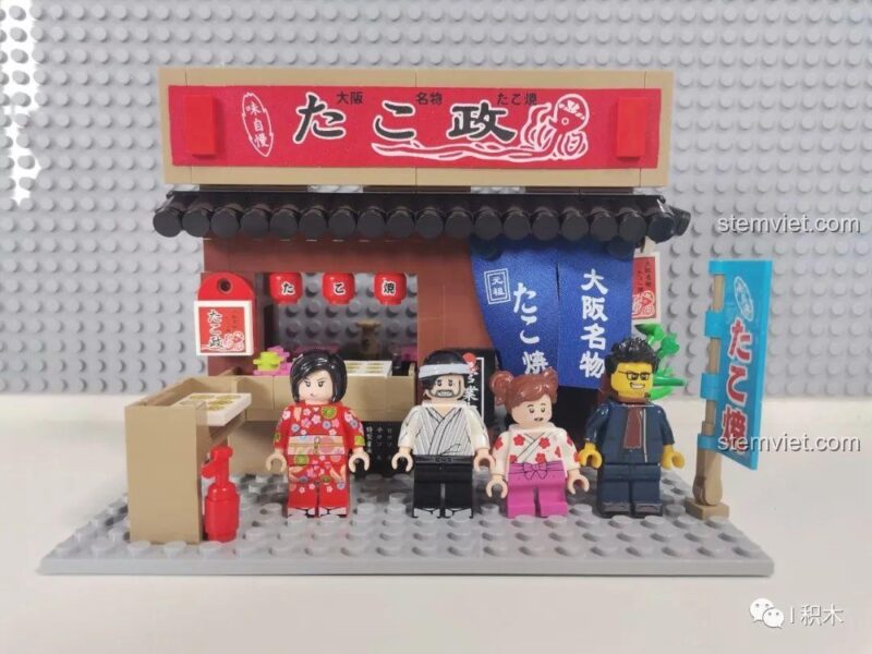 Biển hiệu phụ màu xanh dương của bộ xếp hình Cửa hàng Takoyaki SEMBO 601072, ghi chữ 'Osaka 名物' (Đặc sản Osaka) và 'たこ焼' (Takoyaki).