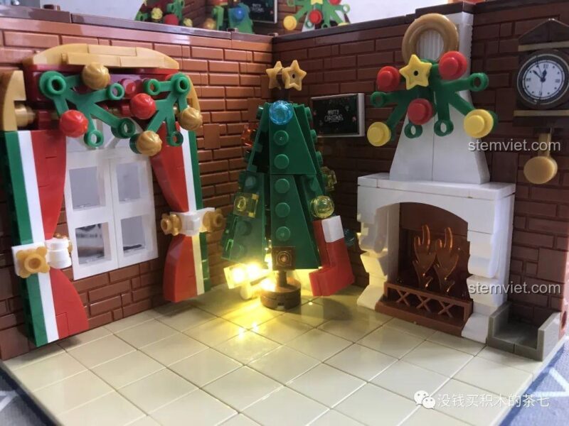 Vòng hoa hoàn thiện trên lò sưởi của bộ lắp ráp Wekki 506001 Phòng Tiệc Giáng Sinh, tạo điểm nhấn cho không gian.