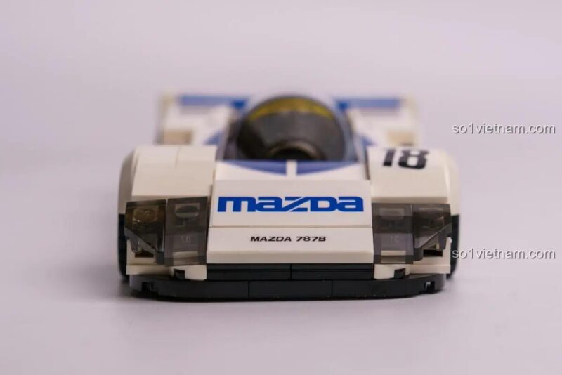 Ảnh review bộ đồ chơi CaDA C55029 Xe đua Mazda 787B do người dùng chụp, mô hình đặt cạnh tạp chí xe, thể hiện sự chân thực, phù hợp bé trai 8 tuổi.