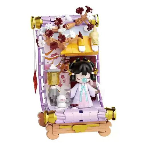 Ảnh chính diện bộ lắp ghép Nanci Màn Đông TC2056 của TOP TOY, mô hình cô bé Nanci ngồi trong khung cảnh mùa đông với người tuyết và mèo con. Đồ chơi cho bé gái 8 tuổi.
